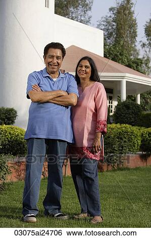 smiling couple standing in front of house View Large Photo Image Stock Photograph - smiling couple standing in front of house. Fotosearch