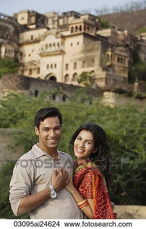 smiling young couple, woman in sari, palace in background View Large Photo Image Picture - smiling young couple, woman in sari, palace in background. Fotosearch
