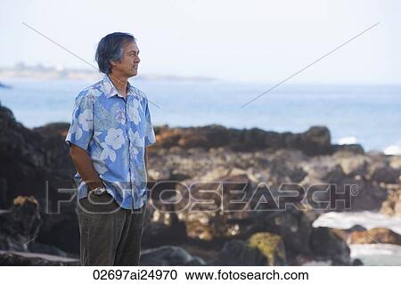 standing on rocks, looking out to sea View Large Photo Image Stock Image - standing on rocks, looking out to sea. Fotosearch