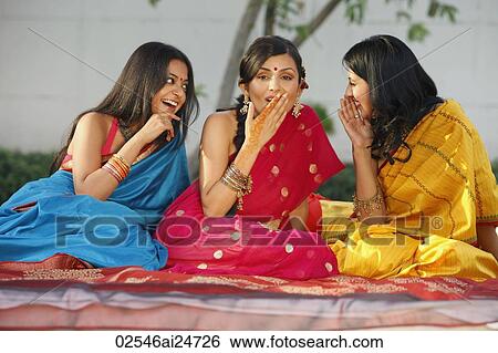 Stock Photograph - three women in saris, gossiping. Fotosearch