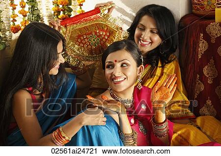 three women in saris, one showing off her henna hands View Large Photo Image Stock Image - three women in saris, one showing off her henna hands. Fotosearch