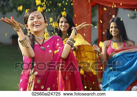 three women in saris, throwing petals View Large Photo Image Stock Photography - three women in saris, throwing petals. Fotosearch