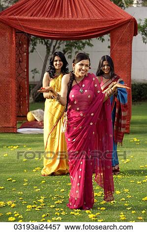 three young women wearing saris, in front of tent View Large Photo Image Stock Photo - three young women wearing saris, in front of tent. Fotosearch