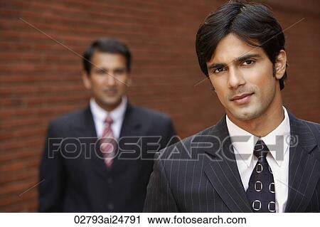 two businessmen, one smiling View Large Photo Image Stock Image - two businessmen, one smiling. Fotosearch