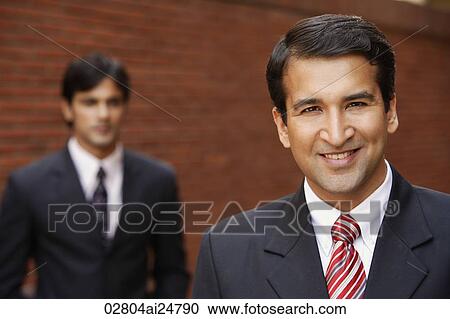 two businessmen, one smiling View Large Photo Image Stock Image - two businessmen, one smiling. Fotosearch
