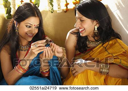 two women in saris, holding jeweled box View Large Photo Image Stock Photo - two women in saris, holding jeweled box. Fotosearch