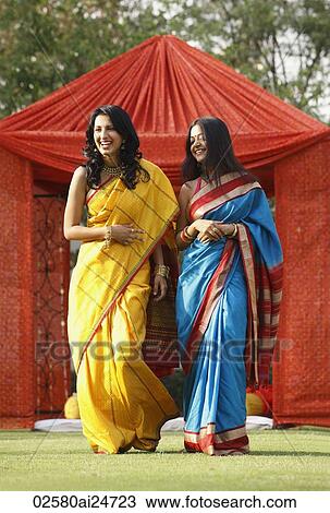 two women in saris in front of red tent View Large Photo Image Stock Image - two women in saris in front of red tent. Fotosearch