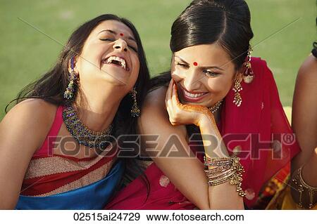 Stock Photo - two women in saris, laughing. Fotosearch