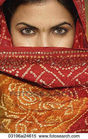 Stock Photography - woman in sari, covering face. Fotosearch