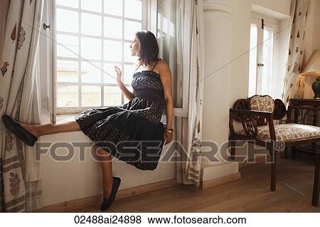 Stock Photo - woman on window sill. Fotosearch