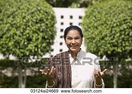 woman outside, smiling and wearing salwar kameez and shawl View Large Photo Image Stock Photo - woman outside, smiling and wearing salwar kameez and shawl. Fotosearch