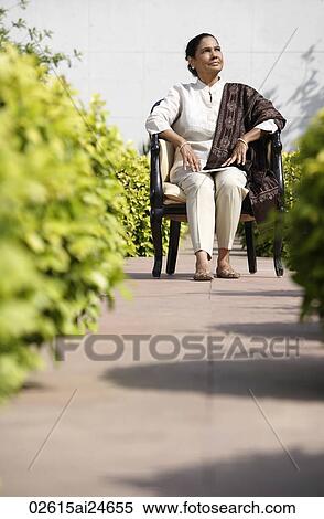 woman sitting on chair outside, wearing salwar kameez and shawl View Large Photo Image Stock Photography - woman sitting on chair outside, wearing salwar kameez and shawl. Fotosearch