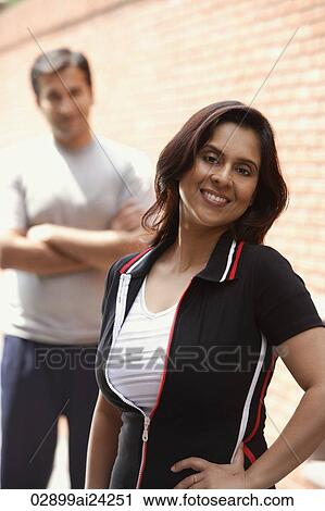 woman smiling, man in background View Large Photo Image Stock Image - woman smiling, man in background. Fotosearch