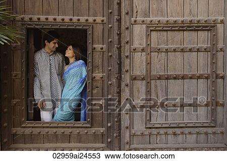 young couple at window in huge wooden doorway View Large Photo Image Stock Image - young couple at window in huge wooden doorway. Fotosearch