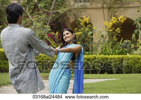 Picture - young couple dancing in garden. Fotosearch
