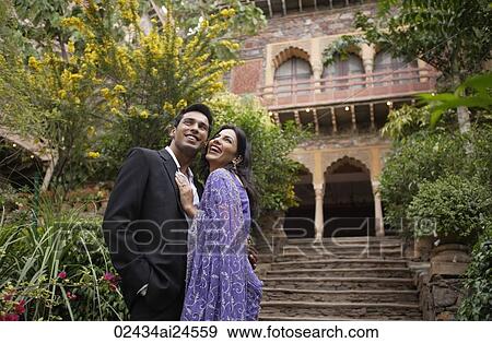Stock Photo - young couple in front of old building, embracing, woman in sari. Fotosearch