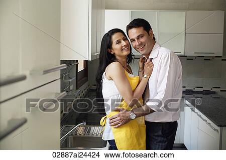 Picture - young couple in kitchen. Fotosearch