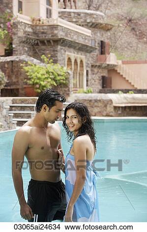 Picture - young couple in pool. Fotosearch