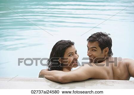 Stock Image - young couple in pool. Fotosearch