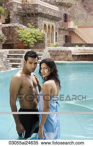 Stock Photography - young couple in pool. Fotosearch