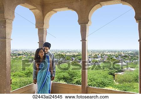 young couple leaning against pillar on terrace balcony View Large Photo Image Stock Photography - young couple leaning against pillar on terrace balcony. Fotosearch