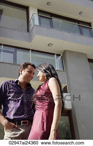 young couple outside apartment looking at each other View Large Photo Image Stock Image - young couple outside apartment looking at each other. Fotosearch