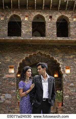 young couple standing in front of traditional brick Indian house, woman in sari View Large Photo Image Stock Image - young couple standing in front of traditional brick Indian house, woman in sari. Fotosearch