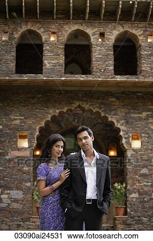 young couple standing in front of traditional brick Indian house, woman in sari View Large Photo Image Stock Image - young couple standing in front of traditional brick Indian house, woman in sari. Fotosearch