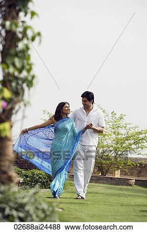 young couple strolling in garden View Large Photo Image Stock Photo - young couple strolling in garden. Fotosearch
