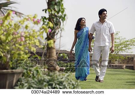 Stock Photo - young couple strolling in garden. Fotosearch