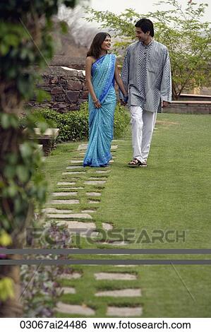 young couple strolling in garden View Large Photo Image Stock Photograph - young couple strolling in garden. Fotosearch