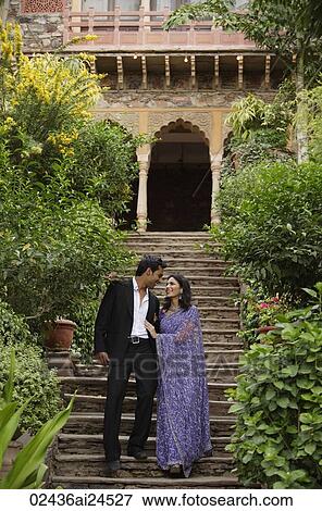 young couple waling arm in arm down stairs, woman in sari View Large Photo Image Stock Photo - young couple waling arm in arm down stairs, woman in sari. Fotosearch