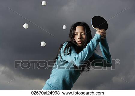 Stock Photo - young lady hitting ping pong balls. Fotosearch