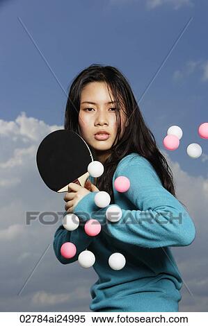 young lady holding bat, ready to hit ping pong balls View Large Photo Image Stock Photography - young lady holding bat, ready to hit ping pong balls. Fotosearch