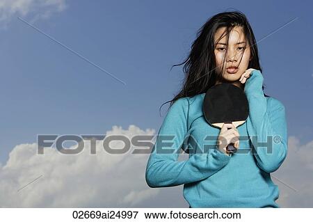 Stock Photo - young lady holding ping pong bat. Fotosearch