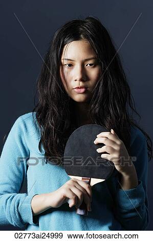 Stock Photo - young lady holding ping pong bat. Fotosearch
