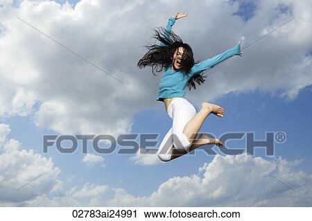 Stock Image - young lady jumping in midair. Fotosearch