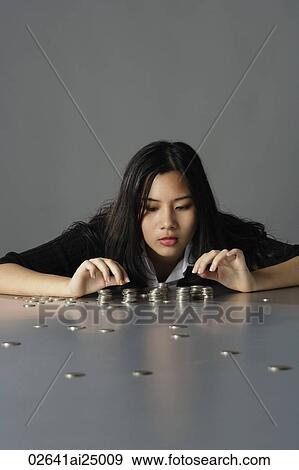 young lady sitting counting coins View Large Photo Image Stock Photo - young lady sitting counting coins. Fotosearch