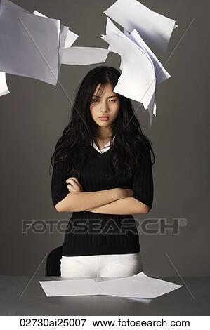 young lady standing, paper falling from above View Large Photo Image Stock Photo - young lady standing, paper falling from above. Fotosearch
