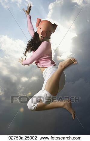 young lady with pig mask, jumping high View Large Photo Image Stock Image - young lady with pig mask, jumping high. Fotosearch