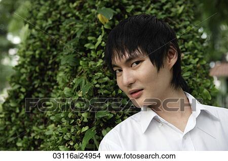 young man in front of tree View Large Photo Image Picture - young man in front of tree. Fotosearch
