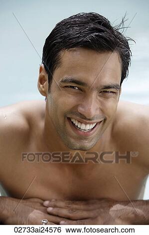 Stock Photograph - young man in pool with big smile. Fotosearch
