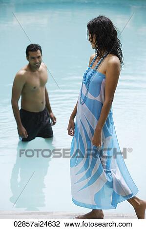young man in pool, woman walking poolside View Large Photo Image Stock Image - young man in pool, woman walking poolside. Fotosearch