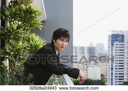 young man in suit at balcony View Large Photo Image Stock Image - young man in suit at balcony. Fotosearch