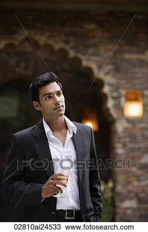 young man in suit with glass of wine in hand View Large Photo Image Stock Image - young man in suit with glass of wine in hand. Fotosearch