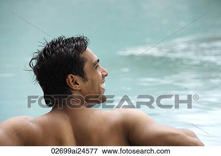 Stock Photo - young man in water, smiling. Fotosearch