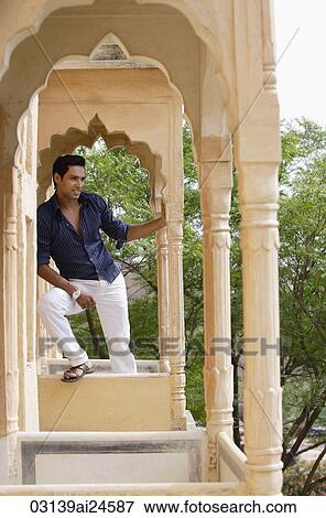 Stock Photo - young man on terrace balcony. Fotosearch