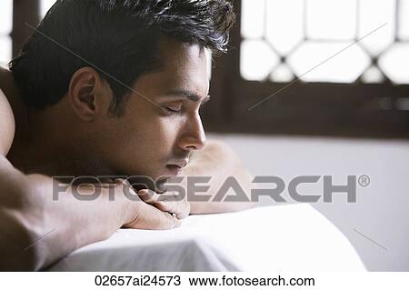 young man relaxing on a massage table View Large Photo Image Stock Image - young man relaxing on a massage table. Fotosearch
