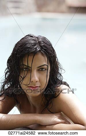 Stock Image - young woman in pool. Fotosearch