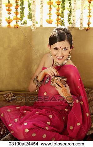 young woman in sari and bindi holding ornate box View Large Photo Image Picture - young woman in sari and bindi holding ornate box. Fotosearch